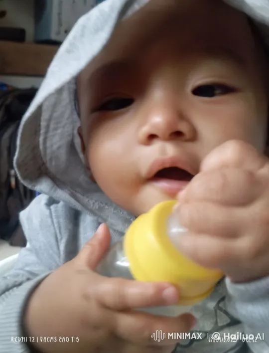Child with Yellow Bottle and Blue-Glowing Eyes – AI Generated Video | Hailuo AI
