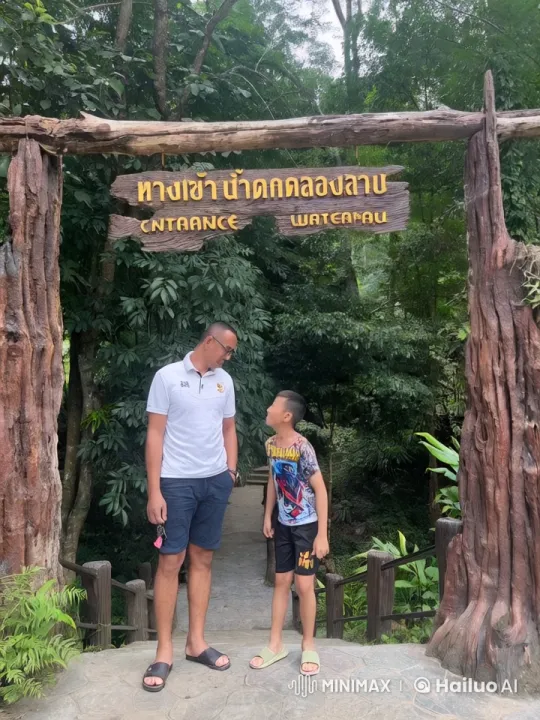 Young Boy Practices Kung Fu at Waterfall Trail Entrance – AI Generated Video | Hailuo AI