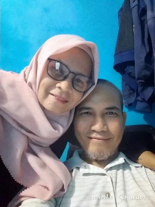 Intimate Couple Shares Tender Kiss Against Blue Wall – AI Generated Video | Hailuo AI
