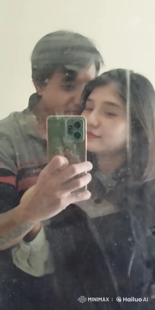 Couple Taking a Relaxed Selfie in a Dusty Mirror – AI Generated Video | Hailuo AI