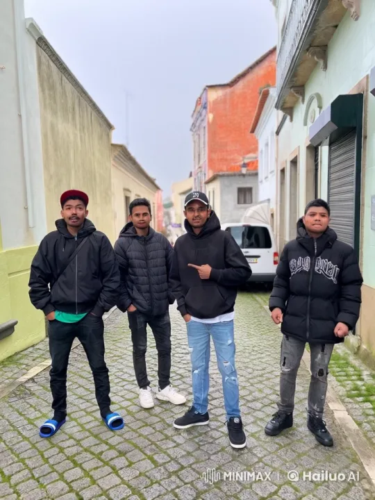 Four Young Men in Casual Streetwear Pose on Cobblestone Street – AI Generated Video | Hailuo AI