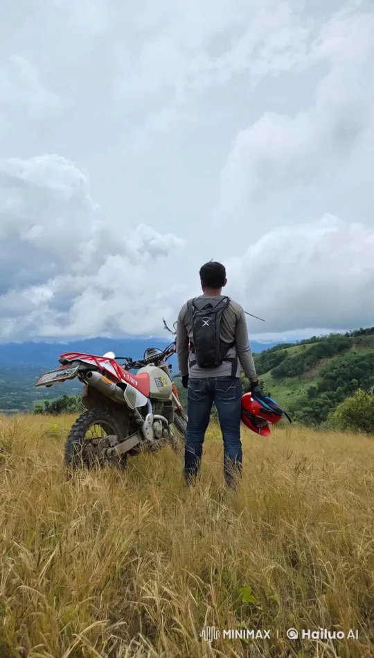 Man with Dirt Bike in Rolling Hills Aerial Scene – AI Generated Video | Hailuo AI