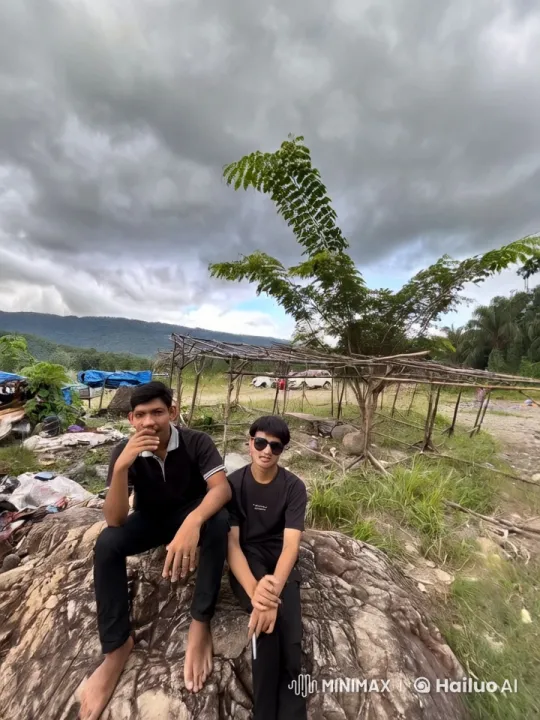 Two Individuals Relaxing on Rock Amidst Outdoor Construction – AI Generated Video | Hailuo AI