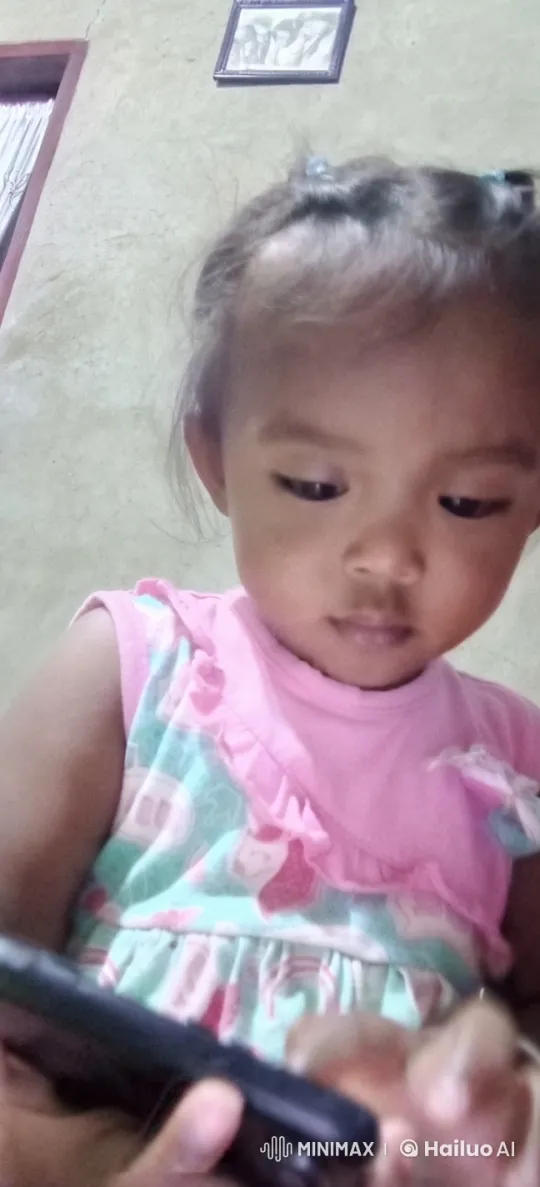 Baby in Pink Dress Engages with Smartphone Indoors – AI Generated Video | Hailuo AI