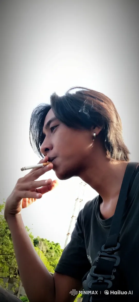 Contemplative Smoking Moment in a Breezy Outdoor Scene – AI Generated Video | Hailuo AI