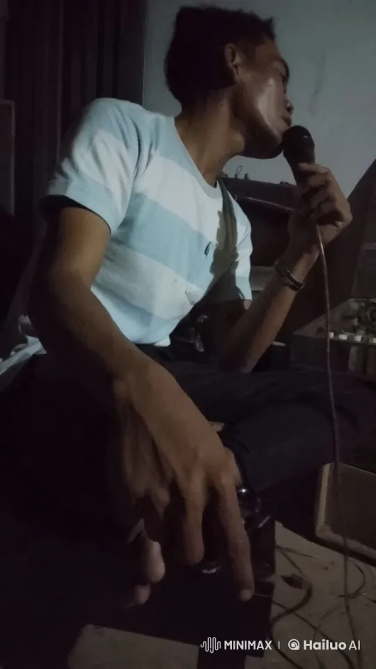 Young Man in Dimly Lit Room with Microphone – AI Generated Video | Hailuo AI