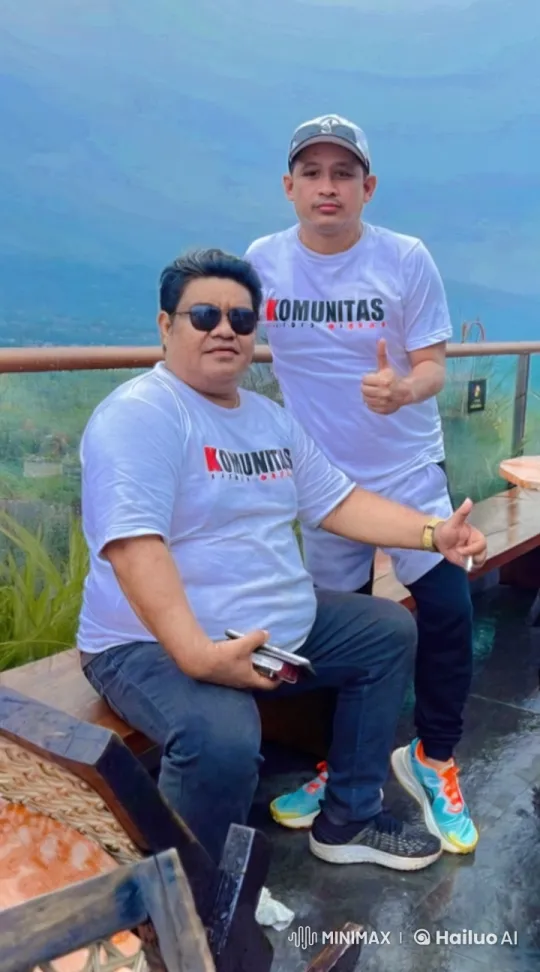 Two Men in Komunitas T-Shirts in Mountainous Landscape – AI Generated Video | Hailuo AI