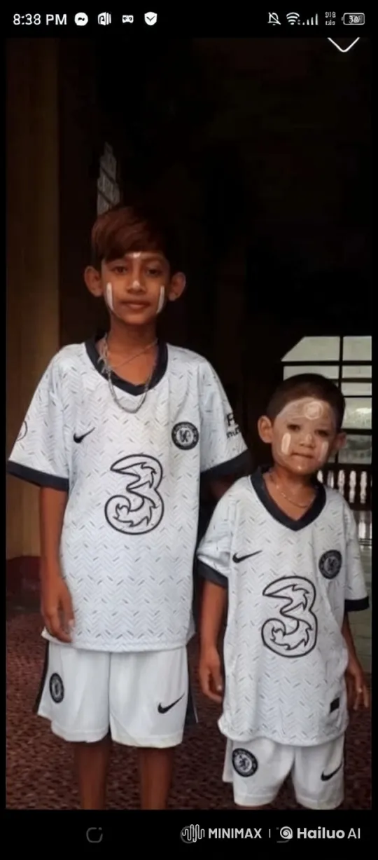 Young Boys in Chelsea FC Jerseys in Dimly Lit Room – AI Generated Video | Hailuo AI