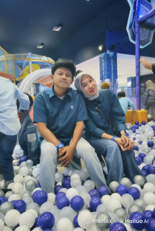 Couple Sitting in a Colorful Ball Pit at Indoor Playground – AI Generated Video | Hailuo AI