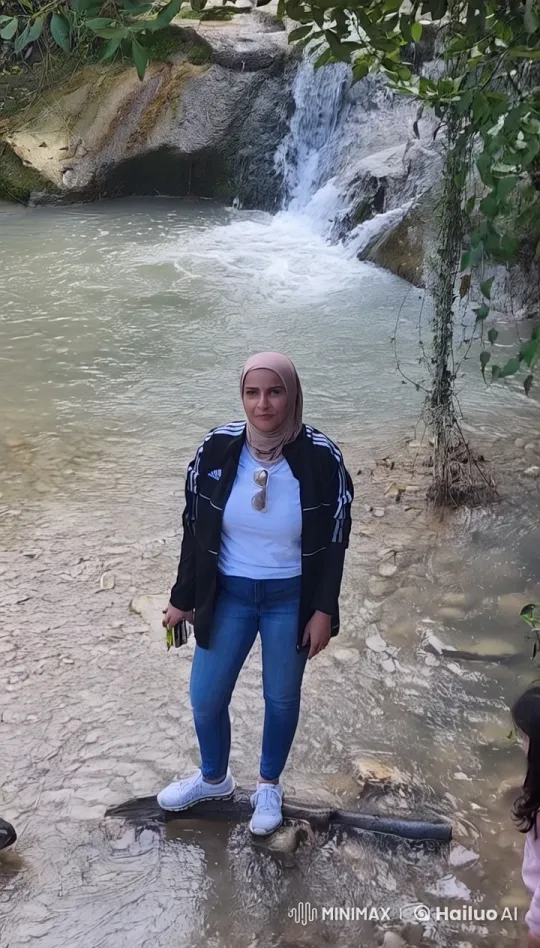 Kaltoum in Nature by Shallow River with Waterfall – AI Generated Video | Hailuo AI