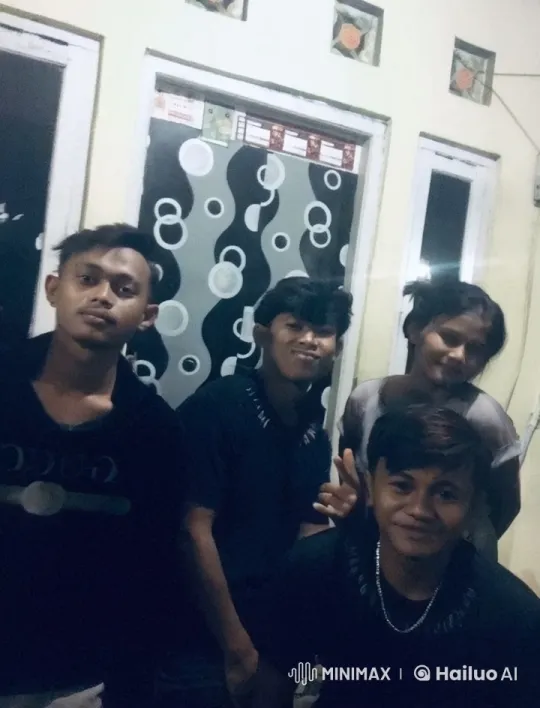 Four Friends Gathered Indoors, Displaying Casual Poses and Peace Sign – AI Generated Video | Hailuo AI