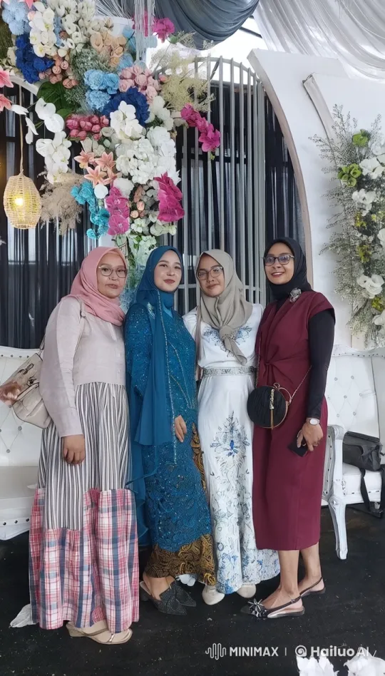 Four Women Pose in Colorful Hijabs Amidst Flower Decor – AI Generated Video | Hailuo AI