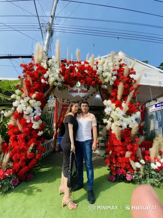 Couple's Energetic Sparring Session in Flower-Adorned Archway – AI Generated Video | Hailuo AI