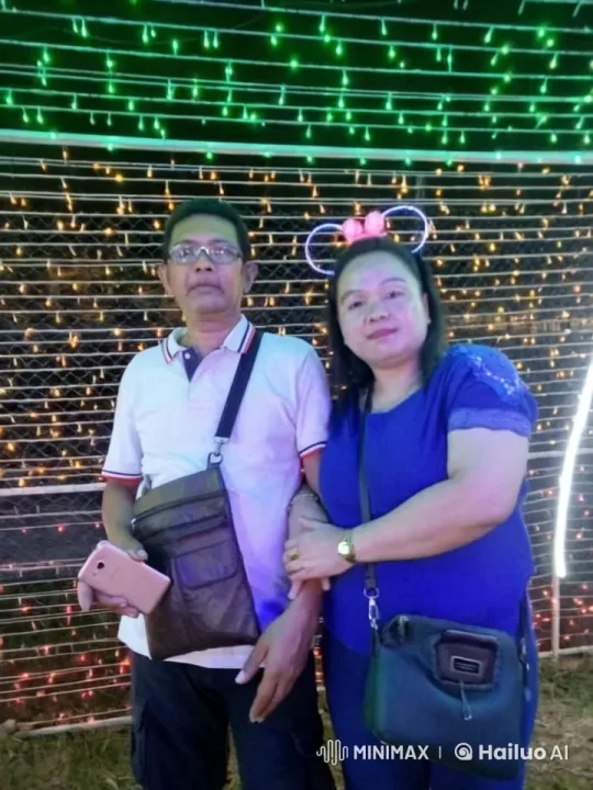 Couple Poses for Photo Under Festive Lights – AI Generated Video | Hailuo AI