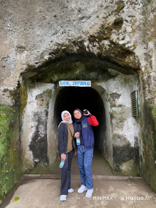 Goa Jepang Cave Entrance with Two People – AI Generated Video | Hailuo AI