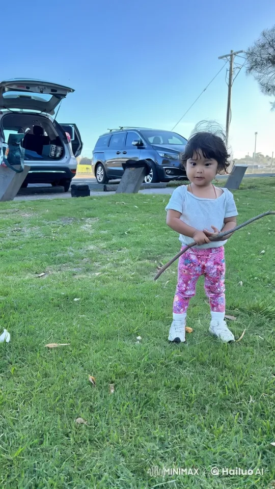 Child Enjoys Playful Martial Arts with Stick in Grass – AI Generated Video | Hailuo AI