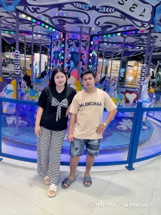 Couple in Front of Brightly Lit Carousel – AI Generated Video | Hailuo AI
