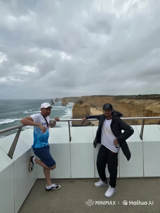Two Men Playfully Exercise on Coastal Cliff with Ocean View – AI Generated Video | Hailuo AI