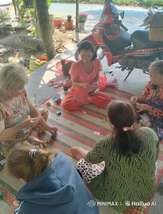 Women Crafting on Mat in Outdoor Setting – AI Generated Video | Hailuo AI