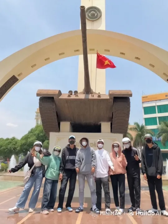 Friends Playfully Brawl in Front of Tank Monument – AI Generated Video | Hailuo AI