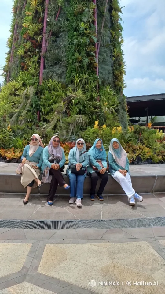 Five Women Chatting on Bench Amidst Lush Vertical Garden – AI Generated Video | Hailuo AI