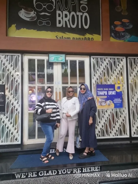 Three Women Pose at 'Kopi Broto' Café Entrance – AI Generated Video | Hailuo AI