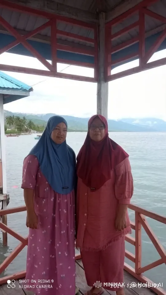Two Women in Hijabs Enjoy Peaceful Moment by Waterfront – AI Generated Video | Hailuo AI