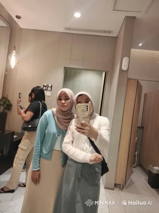 Women Taking Selfie in Modern Restroom with Animated Background – AI Generated Video | Hailuo AI