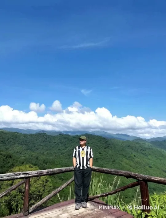 Man on Platform Amidst Mountainous Serenity – AI Generated Video | Hailuo AI