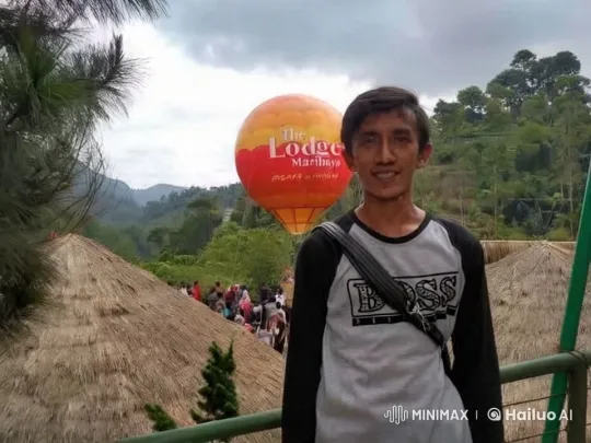 Boy with 'BOSS' Shirt Amidst Enchanted Balloon and Landscape – AI Generated Video | Hailuo AI