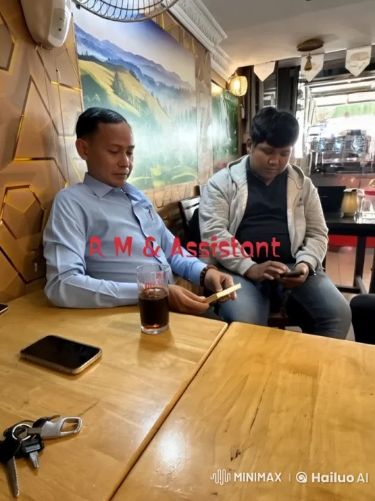 Cozy Café Scene: Two Men Enjoying Drinks and Tech – AI Generated Video | Hailuo AI