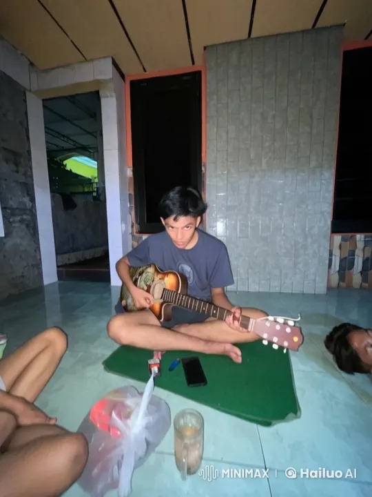 Young Man Plays Guitar in Cozy Room with Friends – AI Generated Video | Hailuo AI