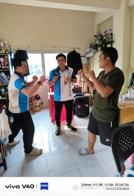 Three Men Prepare for a Friendly Fight in a Cluttered Room – AI Generated Video | Hailuo AI