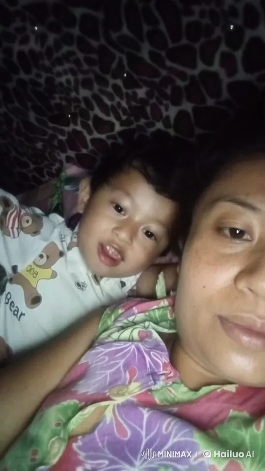 Cozy Child-Adult Scene Under Patterned Blanket – AI Generated Video | Hailuo AI
