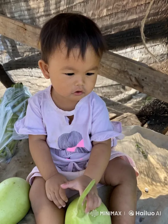 Child Examines Gourd in Natural Outdoor Setting – AI Generated Video | Hailuo AI
