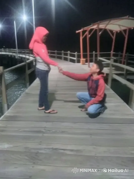 Night Pier Scene: Two Figures Sharing Intimate Support – AI Generated Video | Hailuo AI
