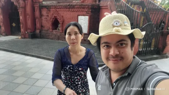Affectionate Couple Kisses in Front of Temple Entrance – AI Generated Video | Hailuo AI