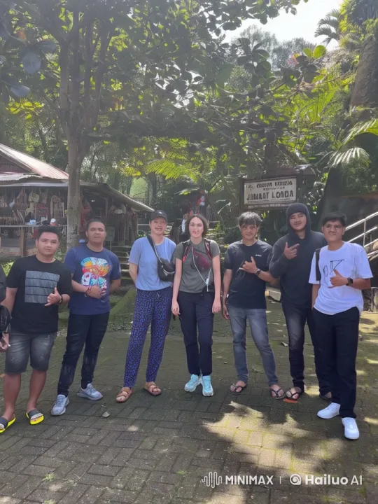 Tourists Pose for Group Photo at Gereja Toraja Londa – AI Generated Video | Hailuo AI