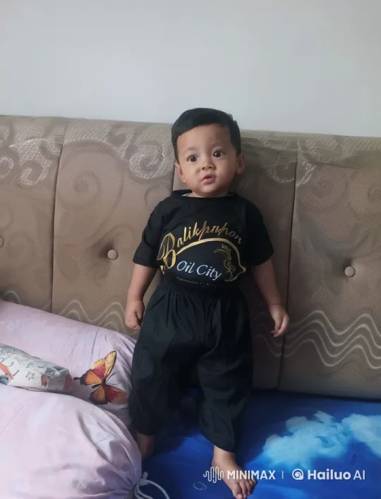 Child Practicing Kungfu on Bed in Balikpapan Shirt – AI Generated Video | Hailuo AI