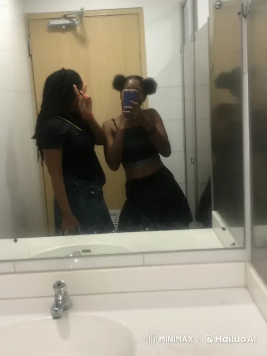 Two Young Women Taking a Selfie in a Bathroom – AI Generated Video | Hailuo AI