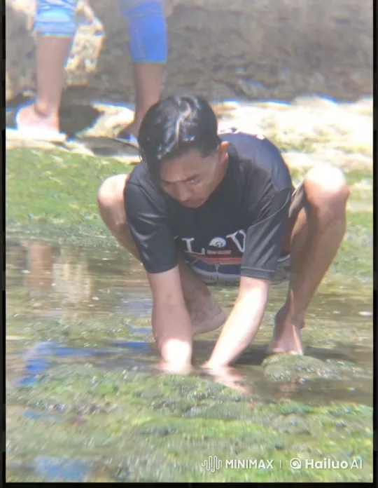 Person Examines Aquatic Life on Shallow Shoreline – AI Generated Video | Hailuo AI