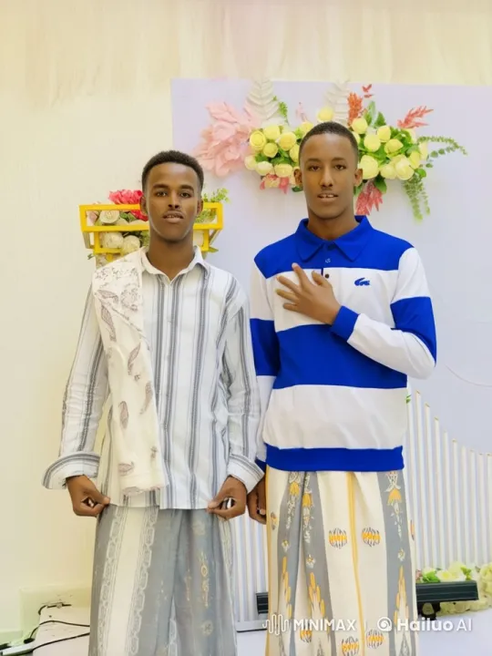 Traditional Attire Men Playfully Fight in Floral Setting – AI Generated Video | Hailuo AI