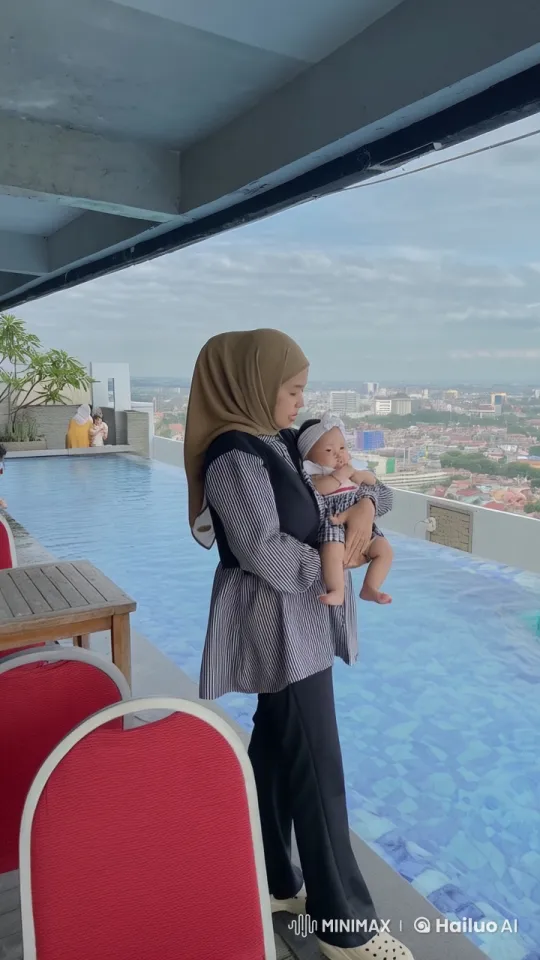 Veiled Woman Practices Kungfu with Baby at Rooftop Infinity Pool – AI Generated Video | Hailuo AI