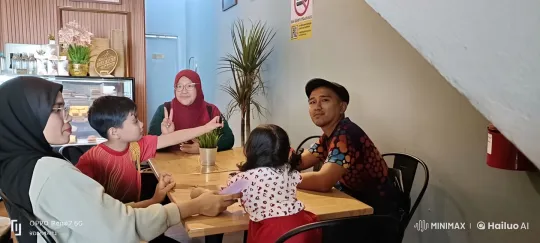 Family Enjoys Kungfu Practice in Cozy Cafe Setting – AI Generated Video | Hailuo AI