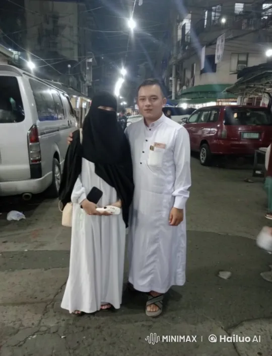 Urban Night Scene: Couple in Traditional Attire Amidst City Life – AI Generated Video | Hailuo AI