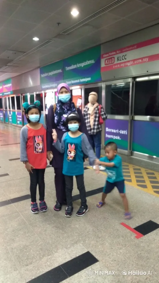 Family Poses with Boy Doing Kungfu at KLCC Metro Exit – AI Generated Video | Hailuo AI