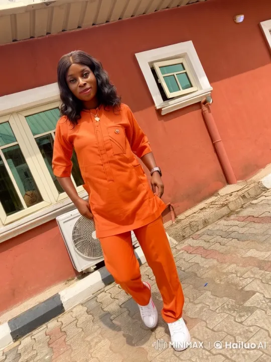 Woman Demonstrates Graceful Kung Fu Moves in Orange Outfit – AI Generated Video | Hailuo AI