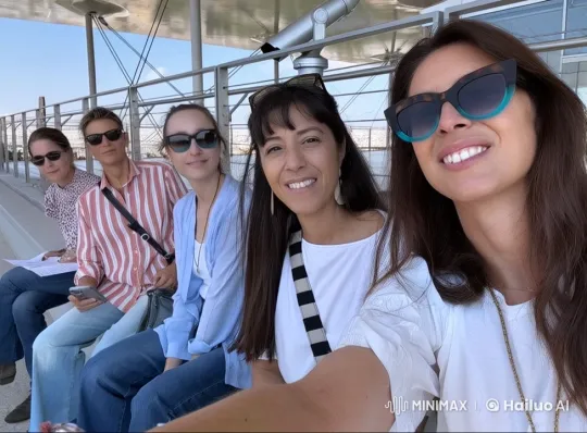 Women Laughing Together on Bench in Animated Cityscape – AI Generated Video | Hailuo AI