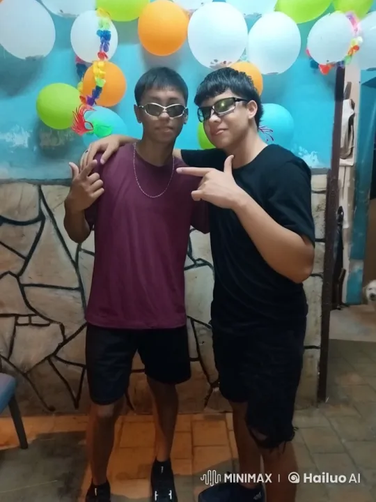 Boys Share Sweet Moment Against Balloon-Decorated Wall – AI Generated Video | Hailuo AI