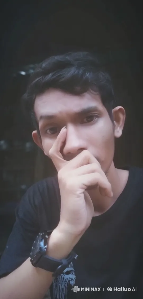 Reflective Portrait with Graphic Shirt and Subdued Lighting – AI Generated Video | Hailuo AI